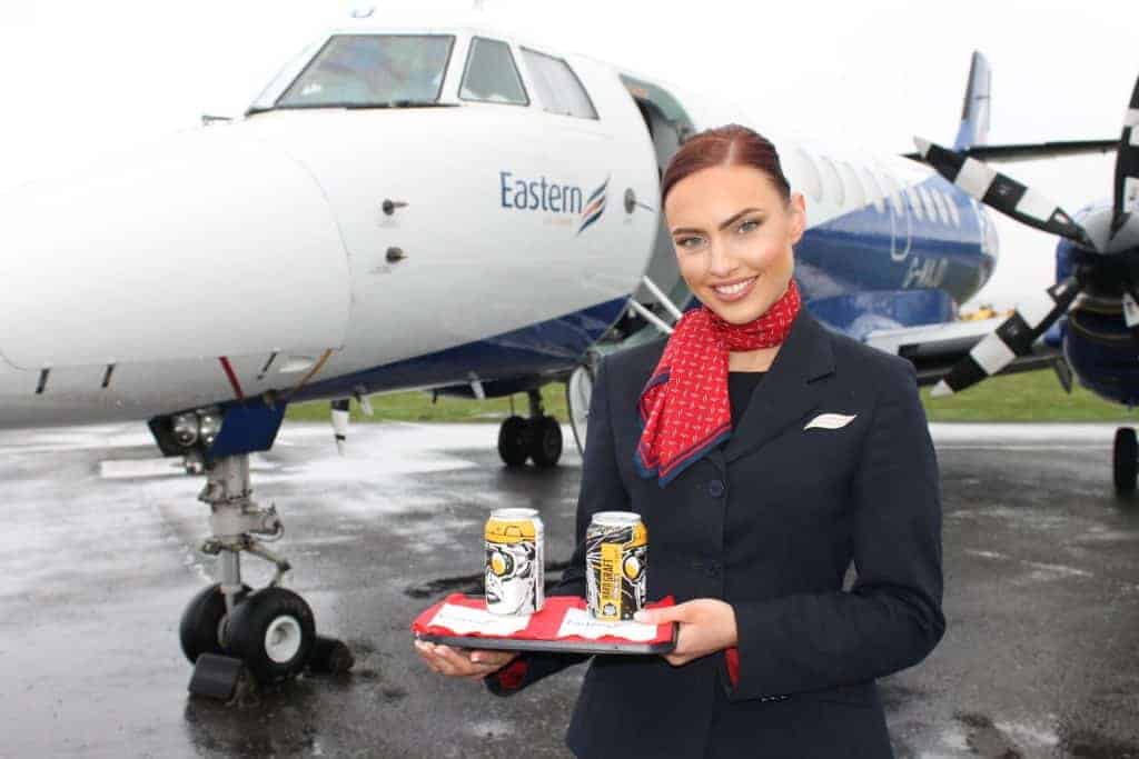 Air hostess holding tray of Docks Beers