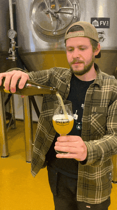 Docks Beers brewer Lewis Birch pouring a bottle of the new Work in Progress IPA range